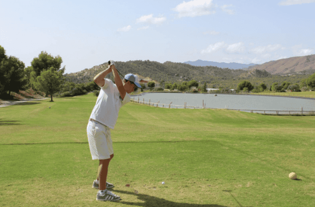 A golfer using Union Jack Golf hire clubs at the scenic Puig Campana Golf course.